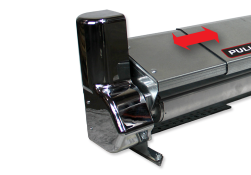 Close-up of a metallic machine end with a chrome lever and a red 'PULL' arrow label on top left edge, suggesting a pull-operated component.